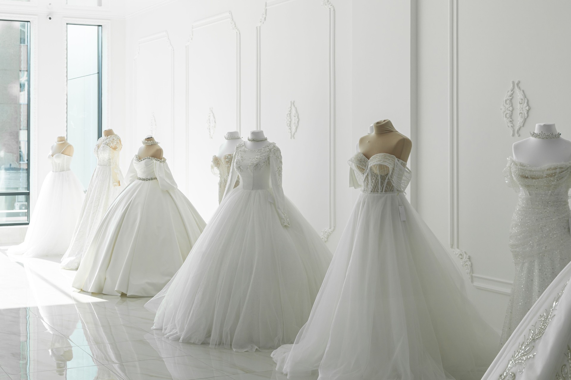 Beautiful wedding bridal dresses on mannequin in showroom in mall.